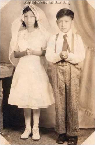 César and his sister are dressed for their First Holy Communion.